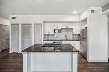 Cabinets with tiled back-splash in kitchen